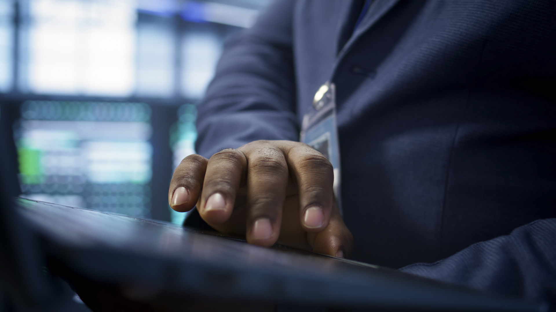 close up shot worker looking data center network issues using laptop