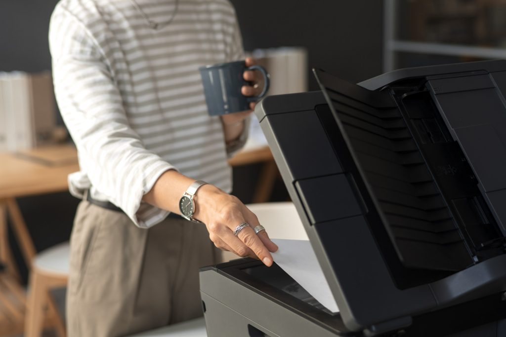 side view employee using printer work